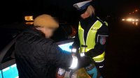 Policjantka wręcza element odblaskowy