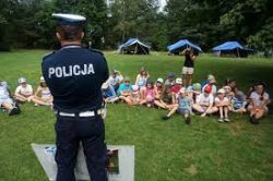 Policjant rozmawia z dziećmi na podwórku