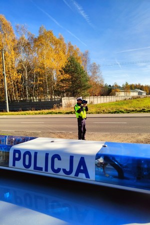 Na zdjęciu policjant z miernikiem prędkości