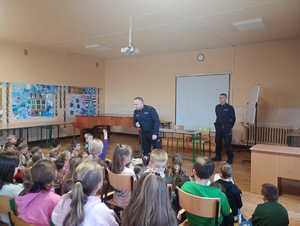 Na zdjęciu uczniowie oraz umundurowani policjanci