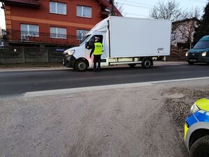 Na zdjęciu widać policjanta ruchu drogowego przeprowadzającego badanie trzeźwości